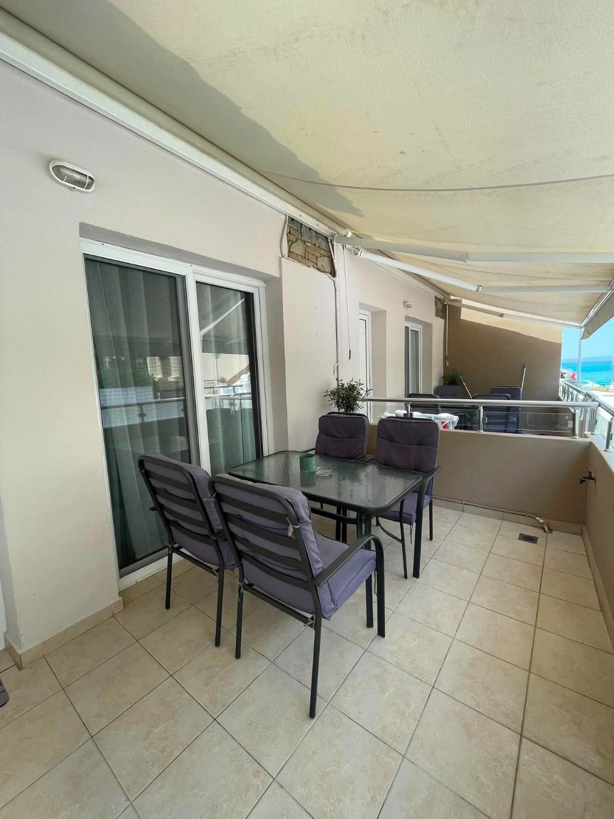 Real furnished balcony of ALYSEA in Pefkochori with a glimpse of the sea