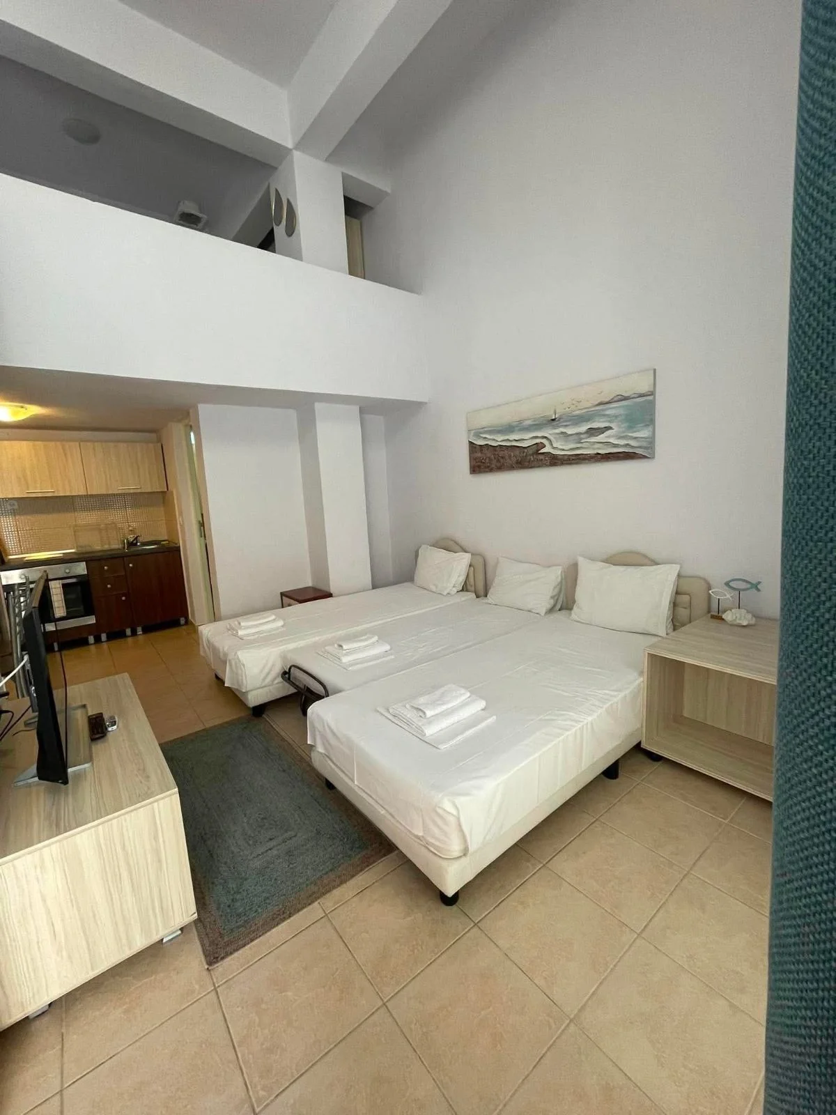 Actual guest room with beds and kitchenette
